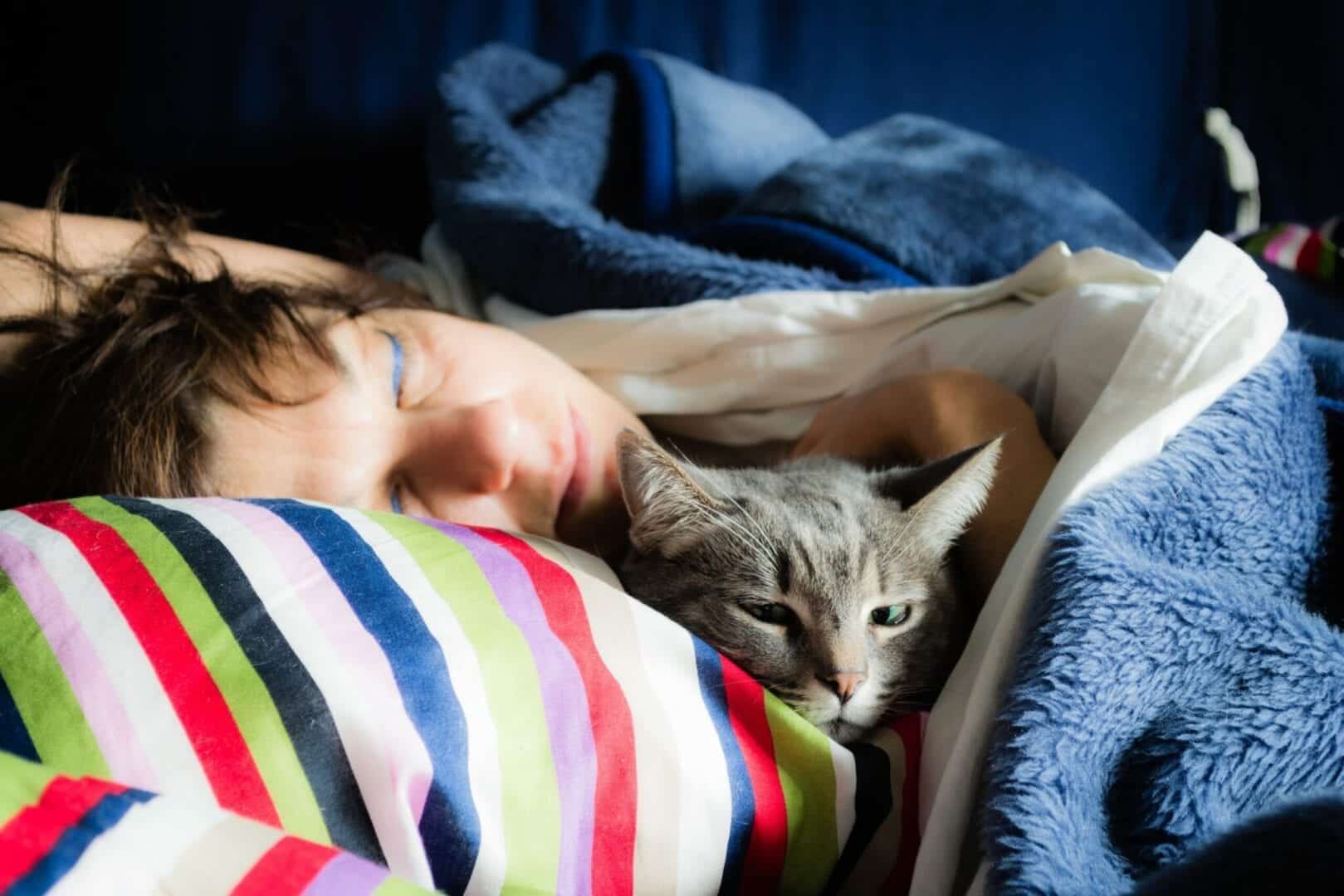 why do cats sleep on your neck?