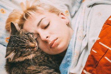 why does my cat sleep by my head?